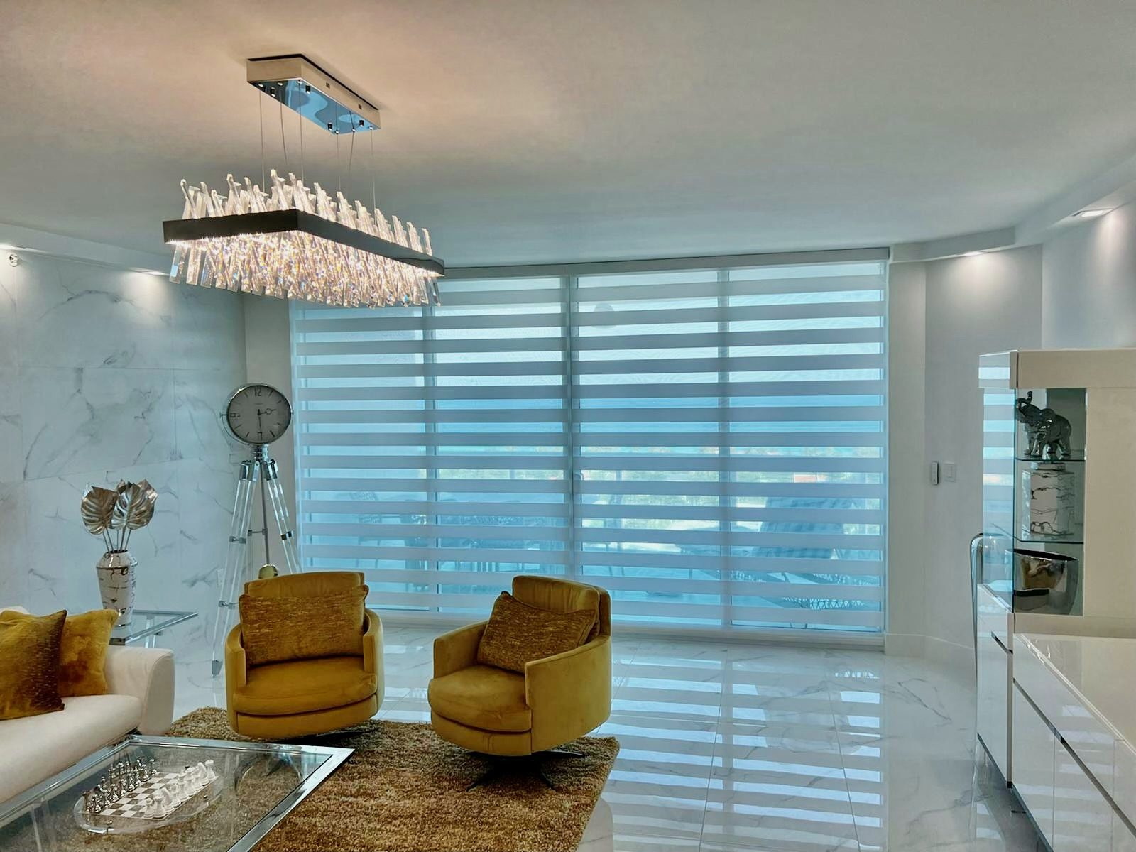 Zebra shades on a wide living room window, alternating sheer and solid bands to tune the light by the hour.