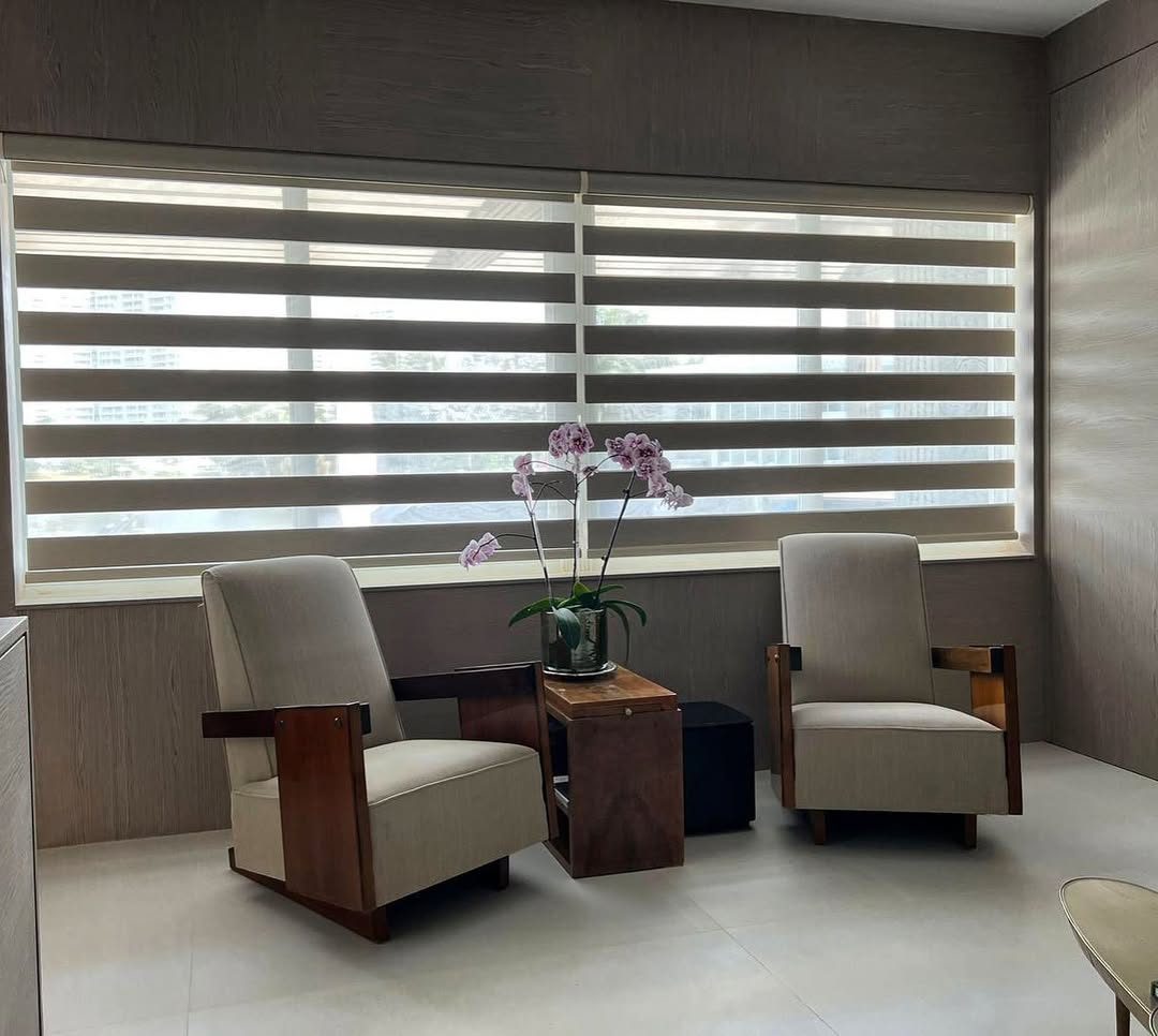 Zebra shades in a panelled office, banded to give privacy at seated eye level and daylight above it.