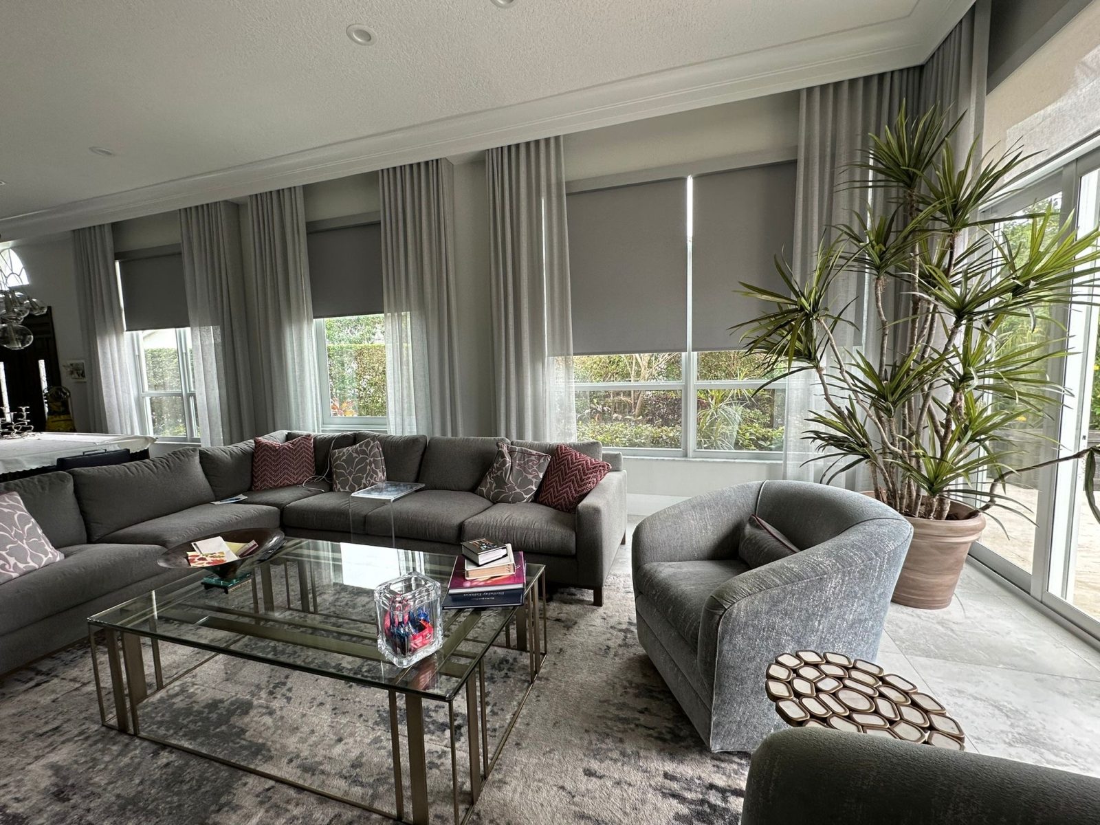 Grey roller shades layered with sheer drapery in a South Florida living room