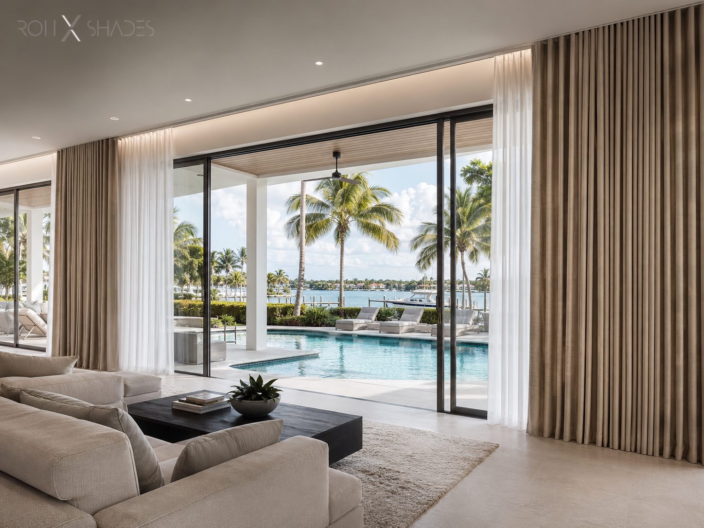 Layered custom drapery framing a bright poolside living room